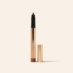 Meroda Eye Perfecting Shimmer Stick in Mauve, geopend in een gouden huls op een lichte achtergrond.